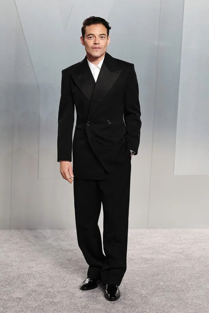 Rami Malek Vanity Fair Oscar Party 2026, Rami Malek black suit Saint Laurent tailoring, Vanity Fair Oscar Party 2026 red carpet Rami Malek, Saint Laurent Vanity Fair Oscar Party Rami Malek, Rami Malek black tuxedo Oscars after party