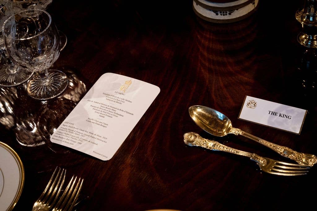 The menu at a State Banquet alongside cutlery