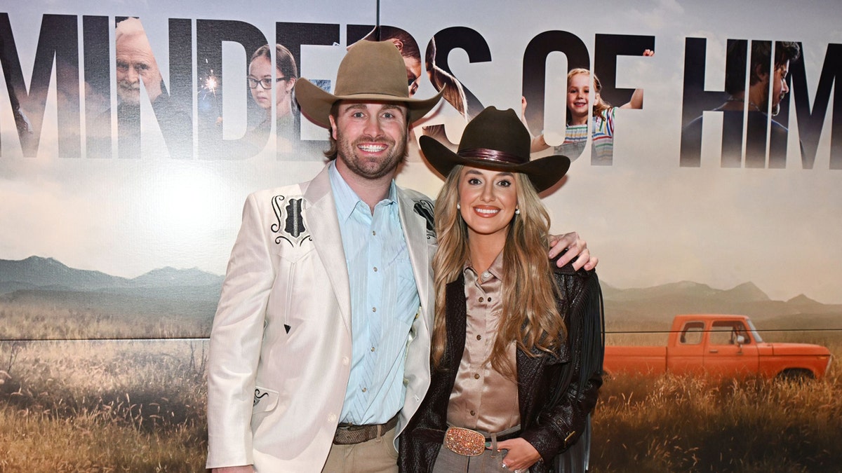 Devlin Hodges and Lainey Wilson standing at a special screening in Nashville.