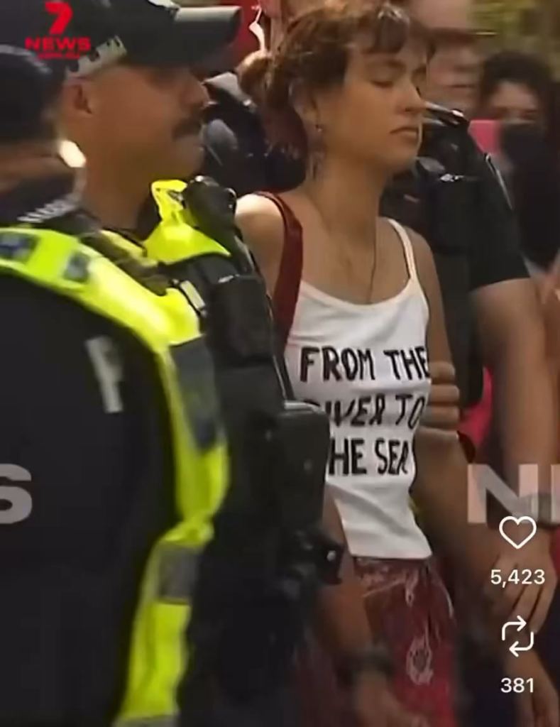 An 18-year-old woman in Queensland faces two years in jail for wearing a shirt that says "from the river to the sea."