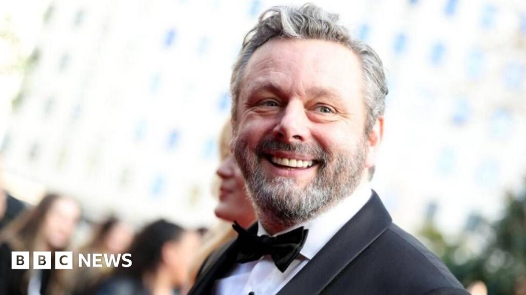 Michael Sheen in a suit and tie