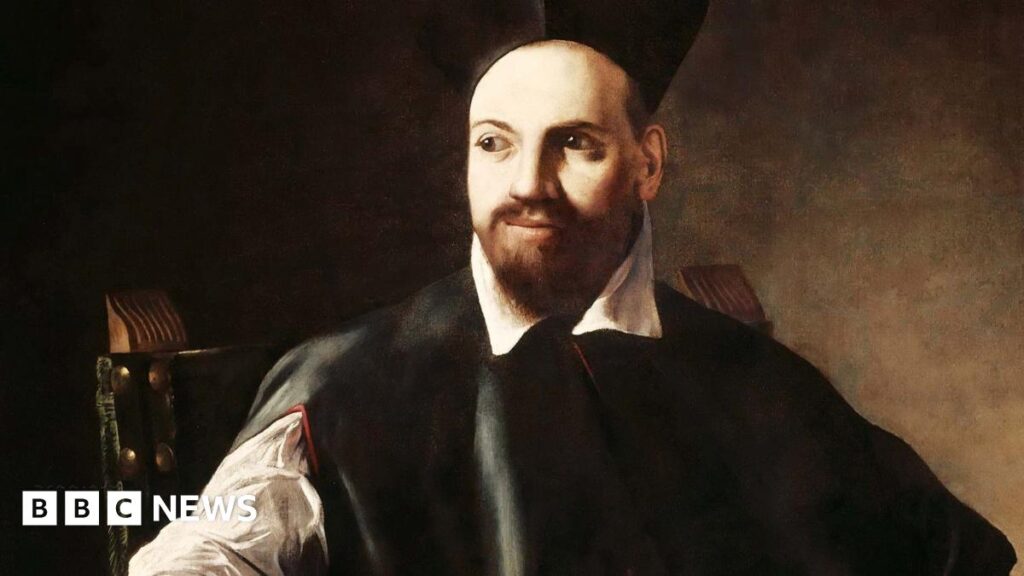 Young person with backpack looks at framed portrait of bearded cleric with a black tricorn hat wearing a dark robe, his right hand outstretched and his left hand clutching a piece of paper