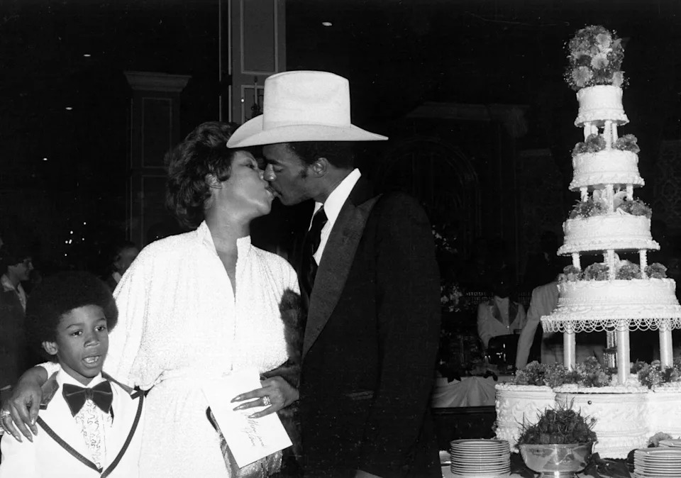 Aretha Franklin and Glynn Turman kiss as her son, Kecalf Franklin, looks on during their wedding at New Bethel Baptist Church in Detroit on April 11, 1978Credit: Michael Ochs Archives/Getty