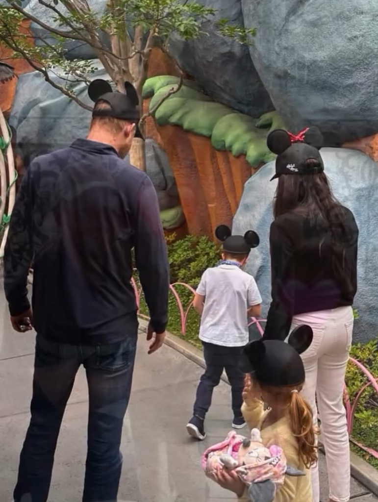 Prince Harry, Meghan Markle, Prince Archie and Princess Lilibet wearing Mickey/Minnie Mouse caps