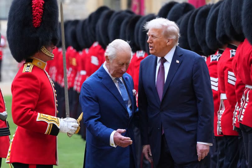 King Charles ushers President Donald Trump during guard of honor on Sept. 17.