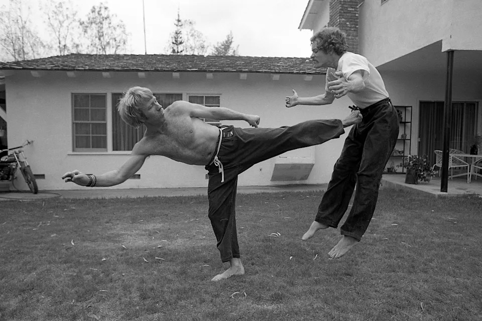 Chuck Norris practices martial arts with his trainer in 1978. 