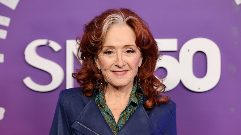 Bonnie Raitt smiling for a photo shoot at a celebrity event