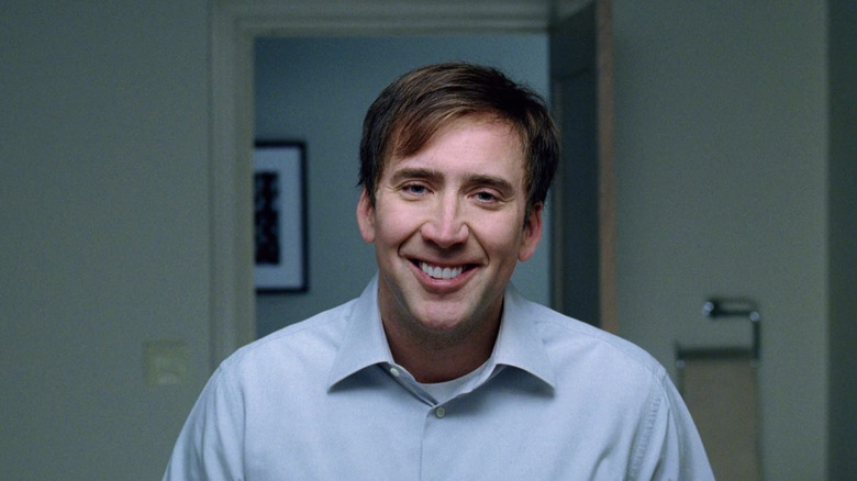 Nicolas Cage forces a smile at the dinner table as David Spritz in The Weather Man