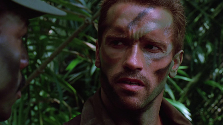 Arnold Schwarzenegger as Dutch wearing war paint in the jungle in Predator