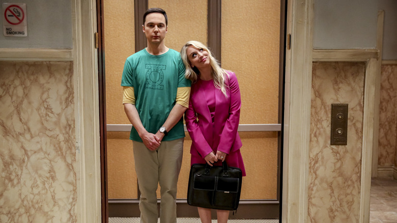 Kaley Cuoco as Penny and Jim Parsons as Sheldon standing in the elevator together in The Big Bang Theory