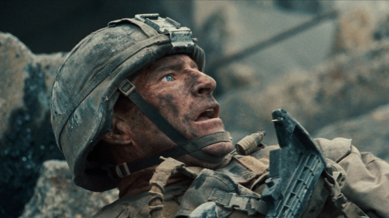 Aaron Eckhart's Michael Nantz looks shocked as he lays in rubble in Battle Los Angeles