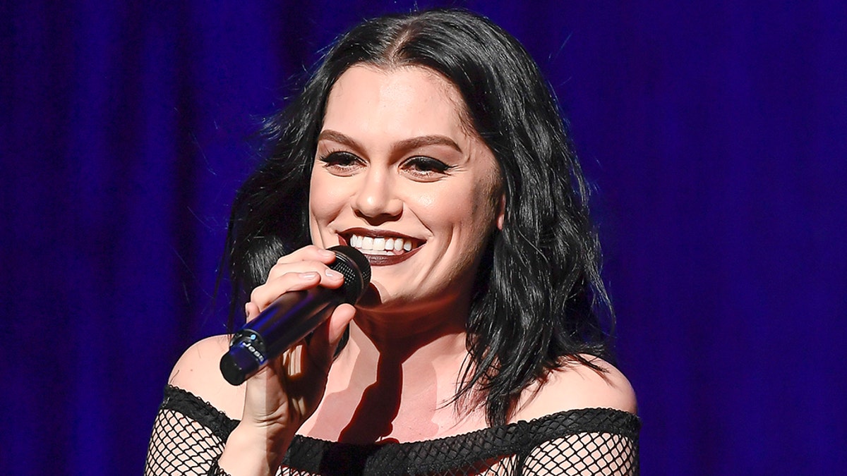 Jessie J holds a microphone