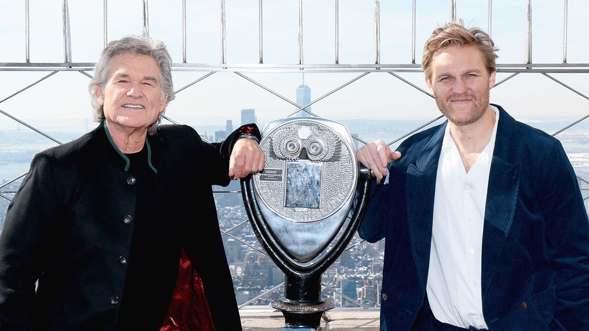 Kurt and Wyatt Russell posing together on top of the Empire State Building.