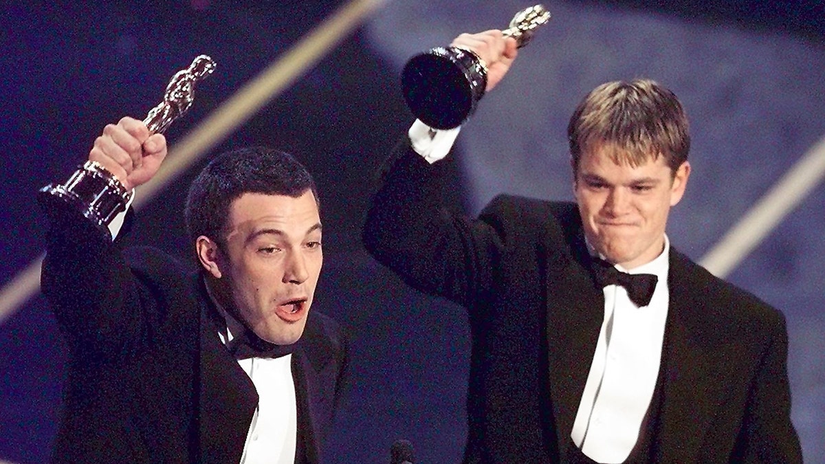 Ben Affleck and Matt Damon accepting their Oscars on stage