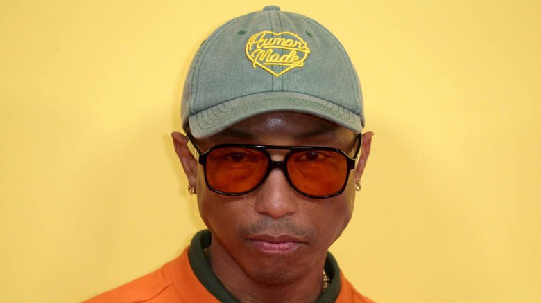 Pharell Williams wearing sunglasses and a cap