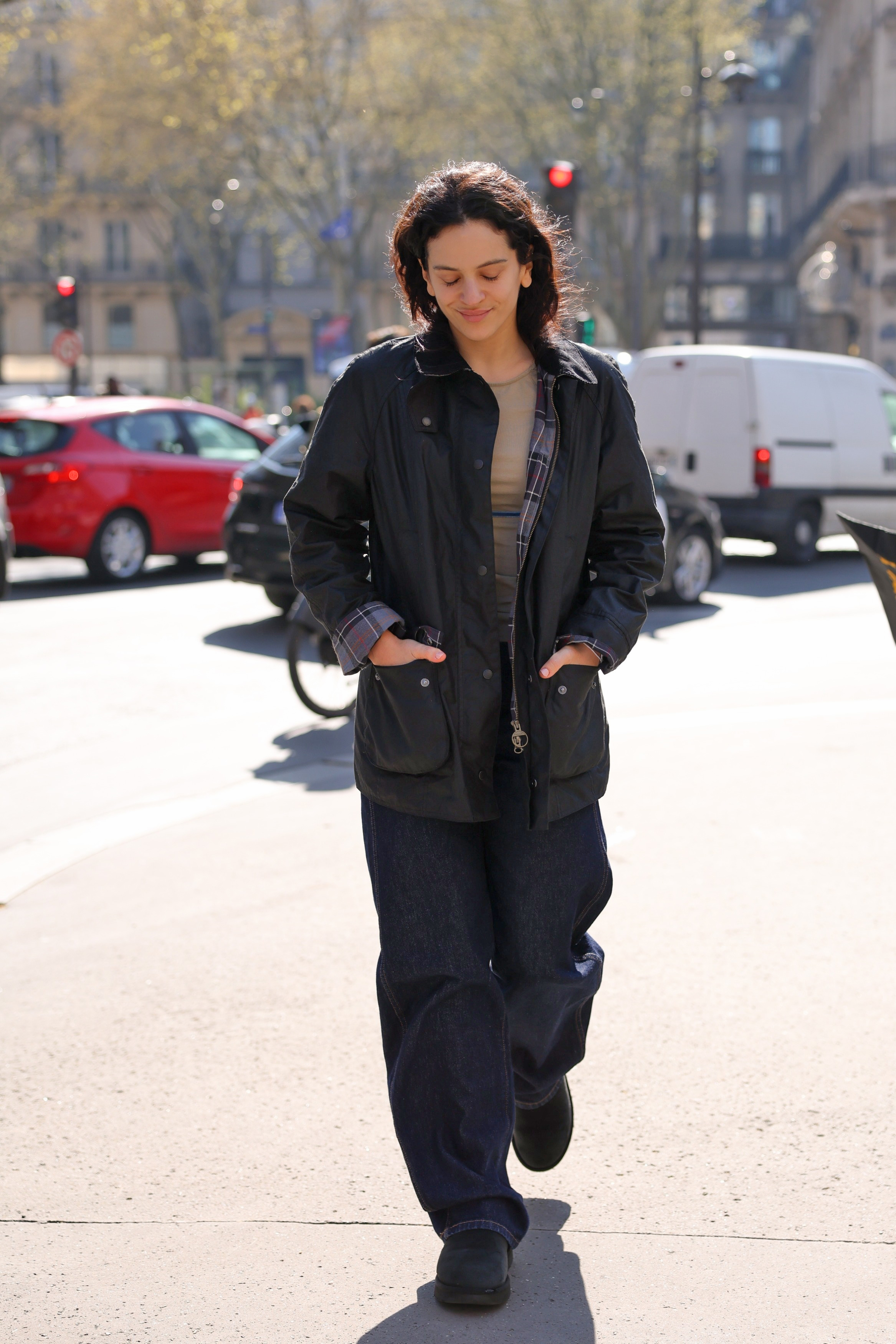 Rosal&iacute;a wearing a barn jacket, a t-shirt, jeans, and boots in Paris on March 19