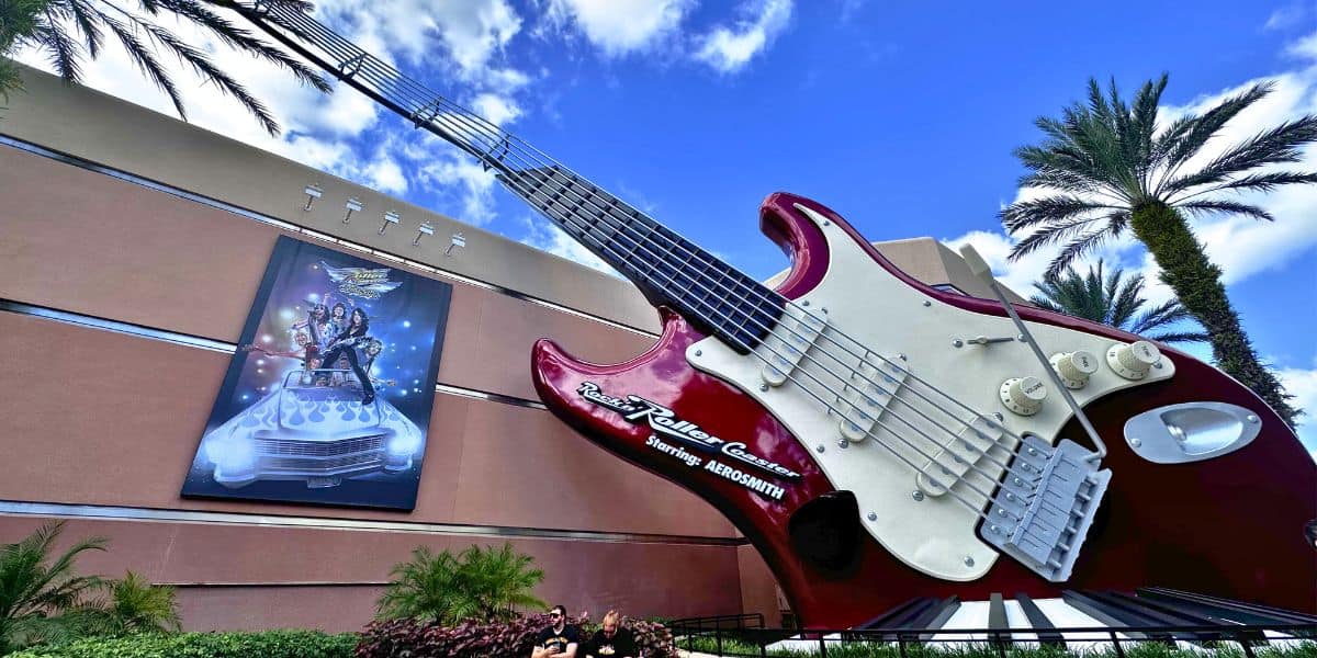 The giant red guitar at Rock 'n' Roller Coaster sets the stage for high-speed thrills, framed by palm trees and sunny skies.