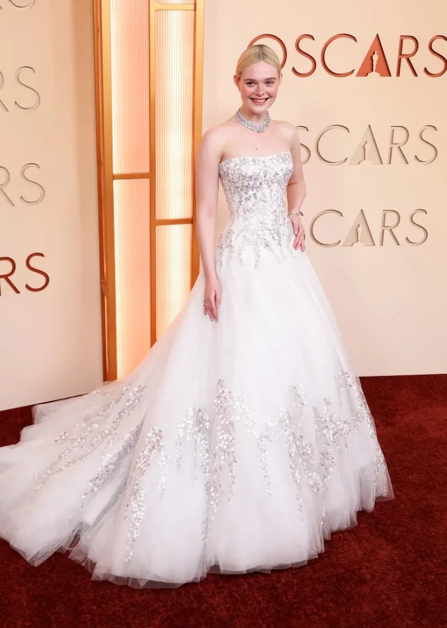 Elle Fanning embraced classic Hollywood elegance in a strapless Givenchy gown and vintage Cartier jewelry at the 2026 Oscars.