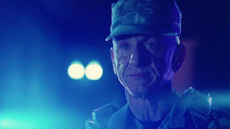 Col. Steven J. Lockjaw (Sean Penn) basked in blue light in One Battle After Another
