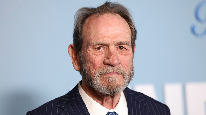 Tommy Lee Jones with beard in black suit and white shirt