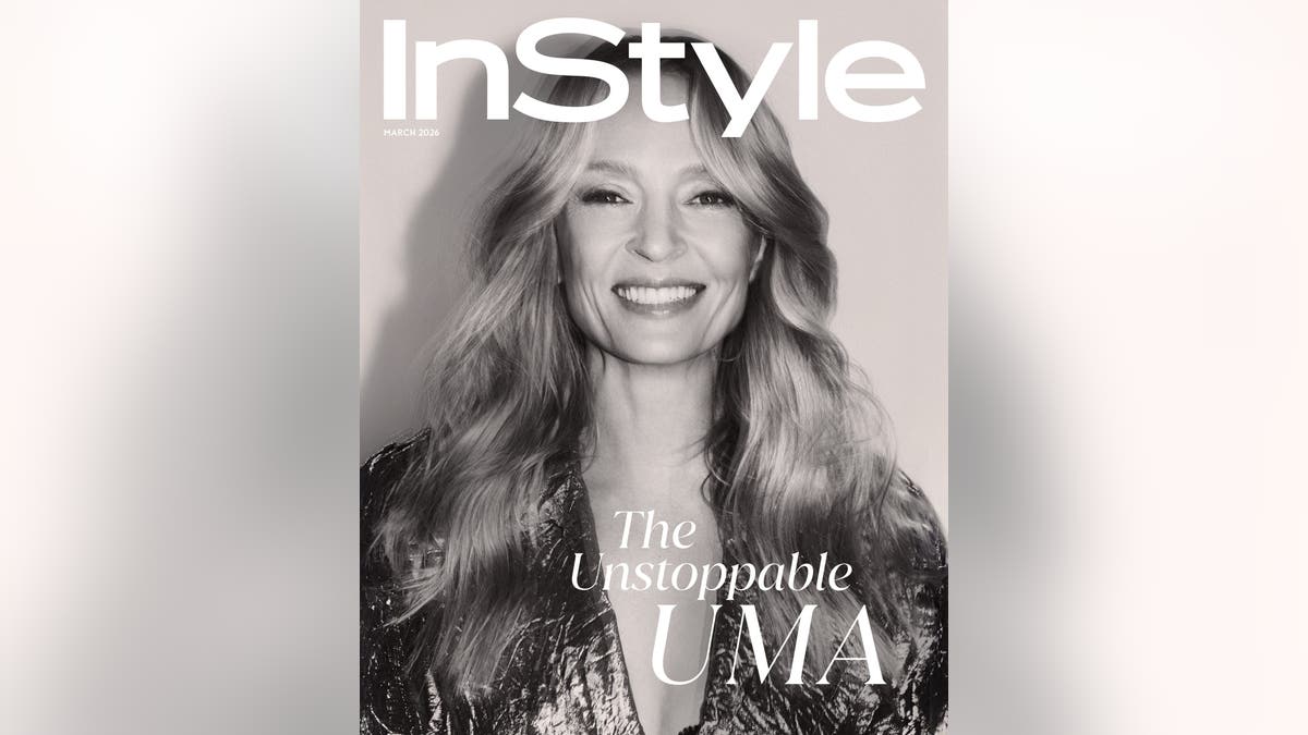 Black-and-white close-up portrait of Uma Thurman smiling warmly, with long wavy blonde hair, on the cover of InStyle magazine.