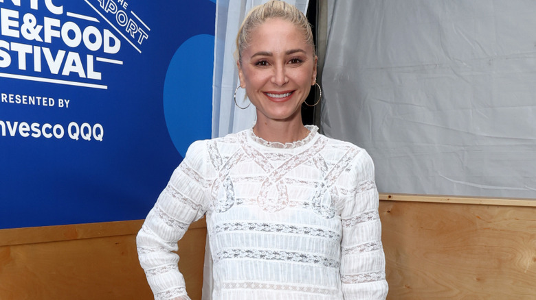 Brooke Williamson smiling in a white dress