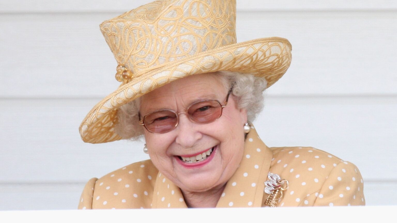 Queen Elizabeth II laughs in the Royal Box as she attends the Queen's Cup final at Guards Polo Club on June 14, 2009