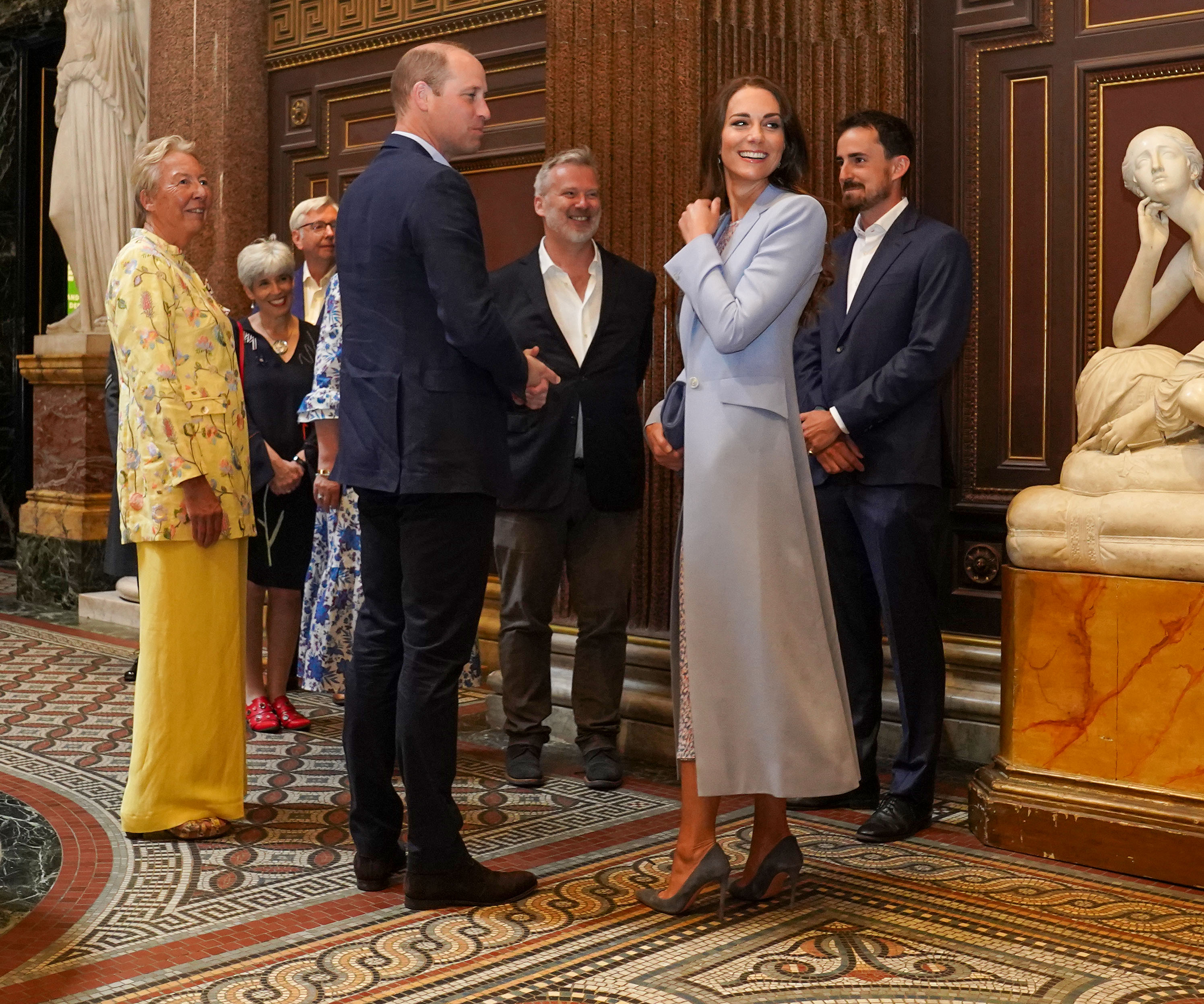 British artist Jamie Coreth poses with his painting of Britain's Prince William, Duke of Cambridge, and Britain's Catherine, Duchess of Cambridge, unveiled at the Fitzwilliam Museum in Cambridge on June 23, 2022