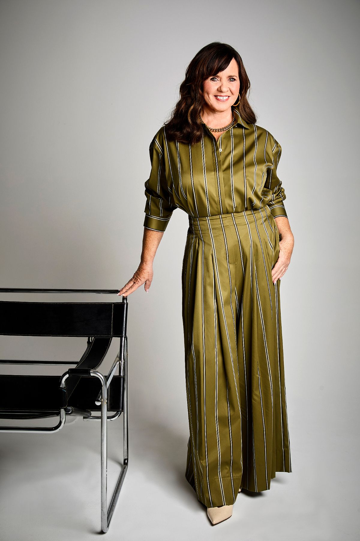 coleen nolan stood up in green satin dress