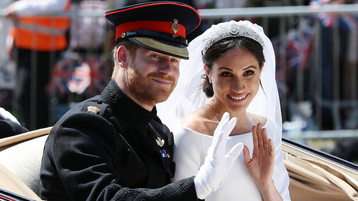 Prince Harry, Duke of Sussex and Meghan, Duchess of Sussex wave from the Ascot Landau Carriage during their carriage procession on Castle Hill outside Windsor Castle in Windsor, on May 19, 2018 after their wedding ceremony.
