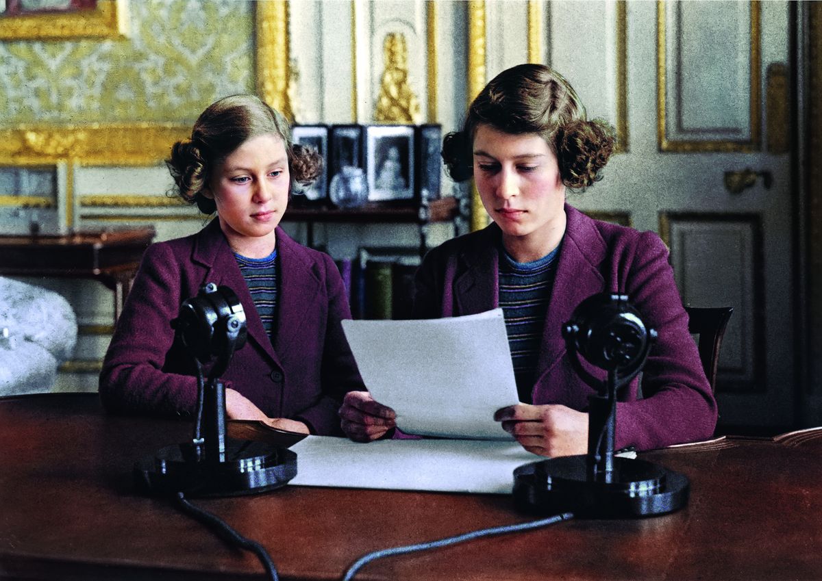 Princesses Elizabeth and Margaret sit side by side in front of a radio microphone on 10th October 1940