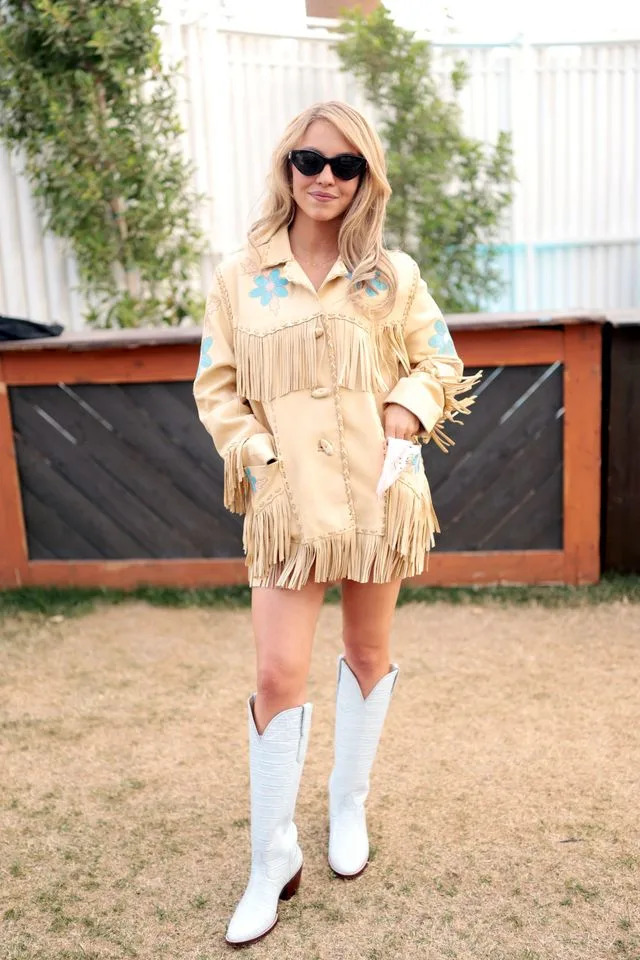 Sweeney wore a yellow fringed jacket and cowboy boots for her festival date with Braun.Credit: Getty