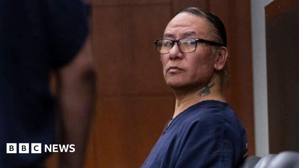 Nathan Chasing Horse appears in court, wearing glasses and a navy detention centre T-shirt, with his hair scraped back