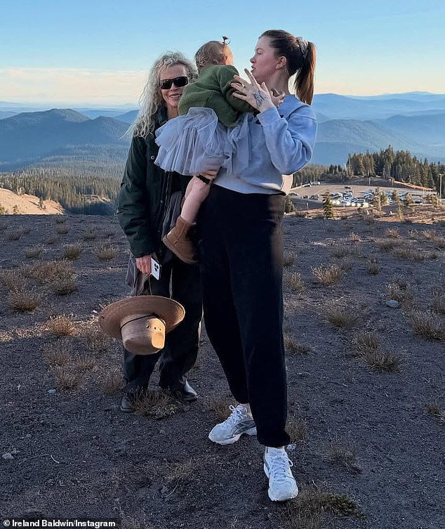 The heavily-tattooed millennial occasionally shares glimpses of her elusive mother - whose last film was Fifty Shades Freed in 2018 - interacting with little Holland (pictured December 18)