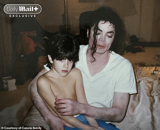 Michael Jackson sits with nine-year-old Dominic Cascio in what the Cascio family believes is a hotel room in 1996. Dominic now says the image reflects the 'fear and confusion' he was experiencing at the time