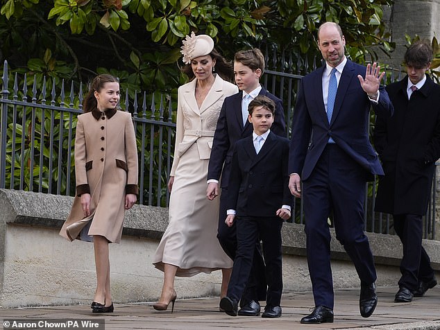 The Prince of Wales waves to the gathering crowd as he arrives alongside Princess Kate and their three children