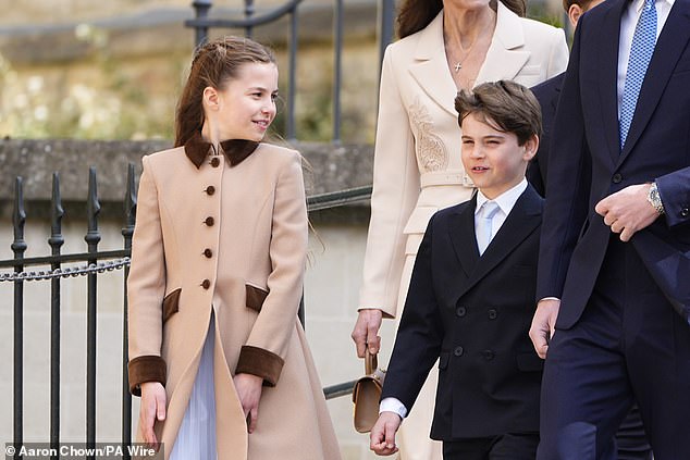 Princess Charlotte looks at her brother Prince Louis as the siblings arrive for the Easter Service