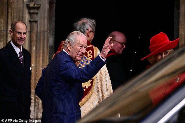 King Charles III waves as he arrives with members of his family at St George's Chapel, in Windsor