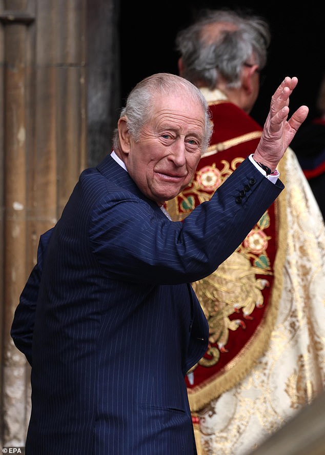 The King waves to the crowd before entering St George's Chapel at Windsor Castle for the Easter Service