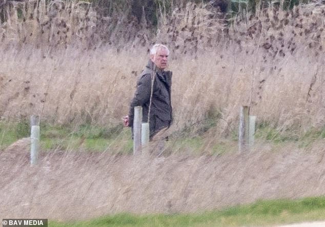 Andrew Mountbatten-Windsor is pictured walking his dogs on the Sandringham estate on Saturday, April 4, 2026
