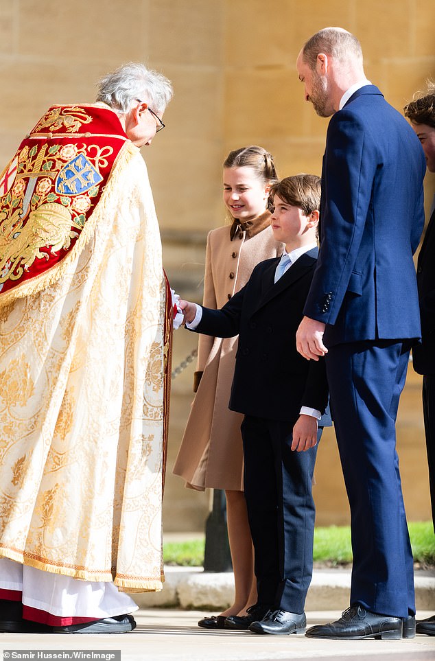 Prince Louis shakes hands as Princess Charlotte and their father Prince William look on