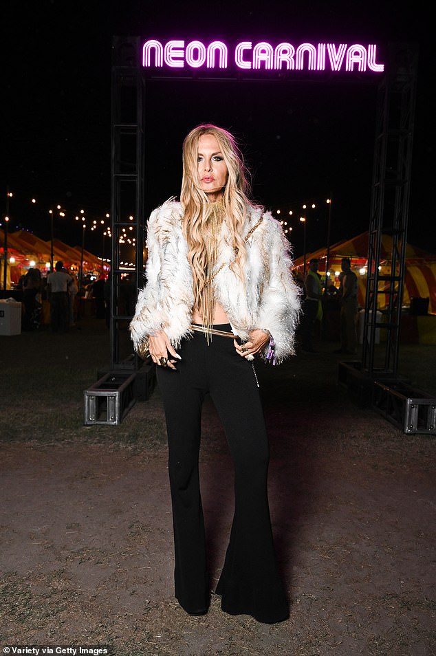 Rachel Zoe, 54, also dressed to impress for Saturday night at Coachella. She appeared to be topless underneath a white, fur jacket and a gold, statement necklace with long fringe