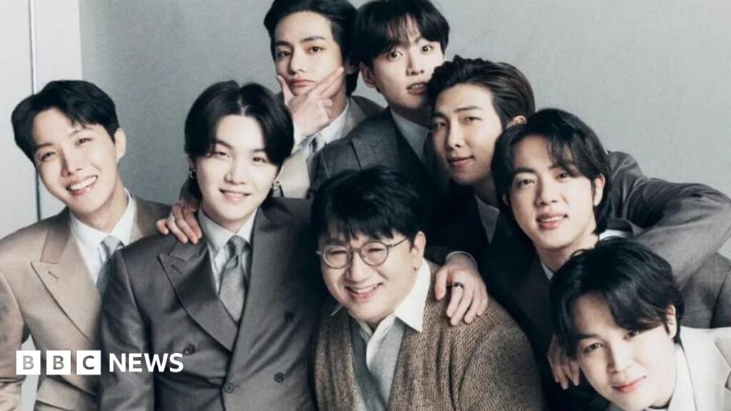 Bang Si-hyuk (centre) and K-pop group BTS