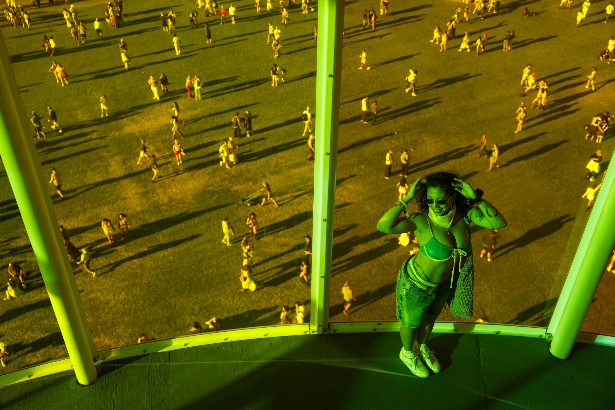 Natalie Villegas  poses for a photos inside the SPECTRA above the grounds where festivalgoers walk around.