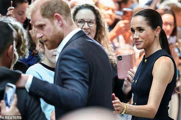 Meghan, Duchess of Sussex reacts as Prince Harry, the Duke of Sussex, greets a person during their visit to the Royal Children's Hospital, in Melbourne, Australia, April 14, 2026. REUTERS/Mark Peterson