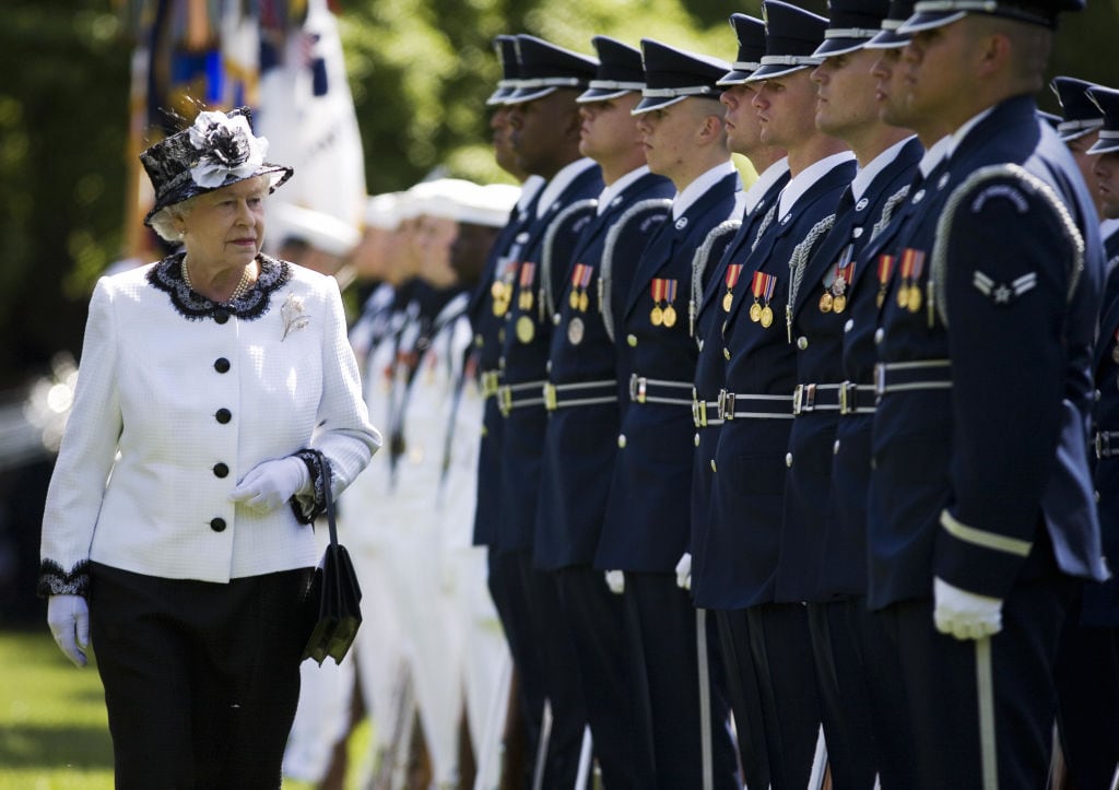 A person walks along a line of soldiers.
