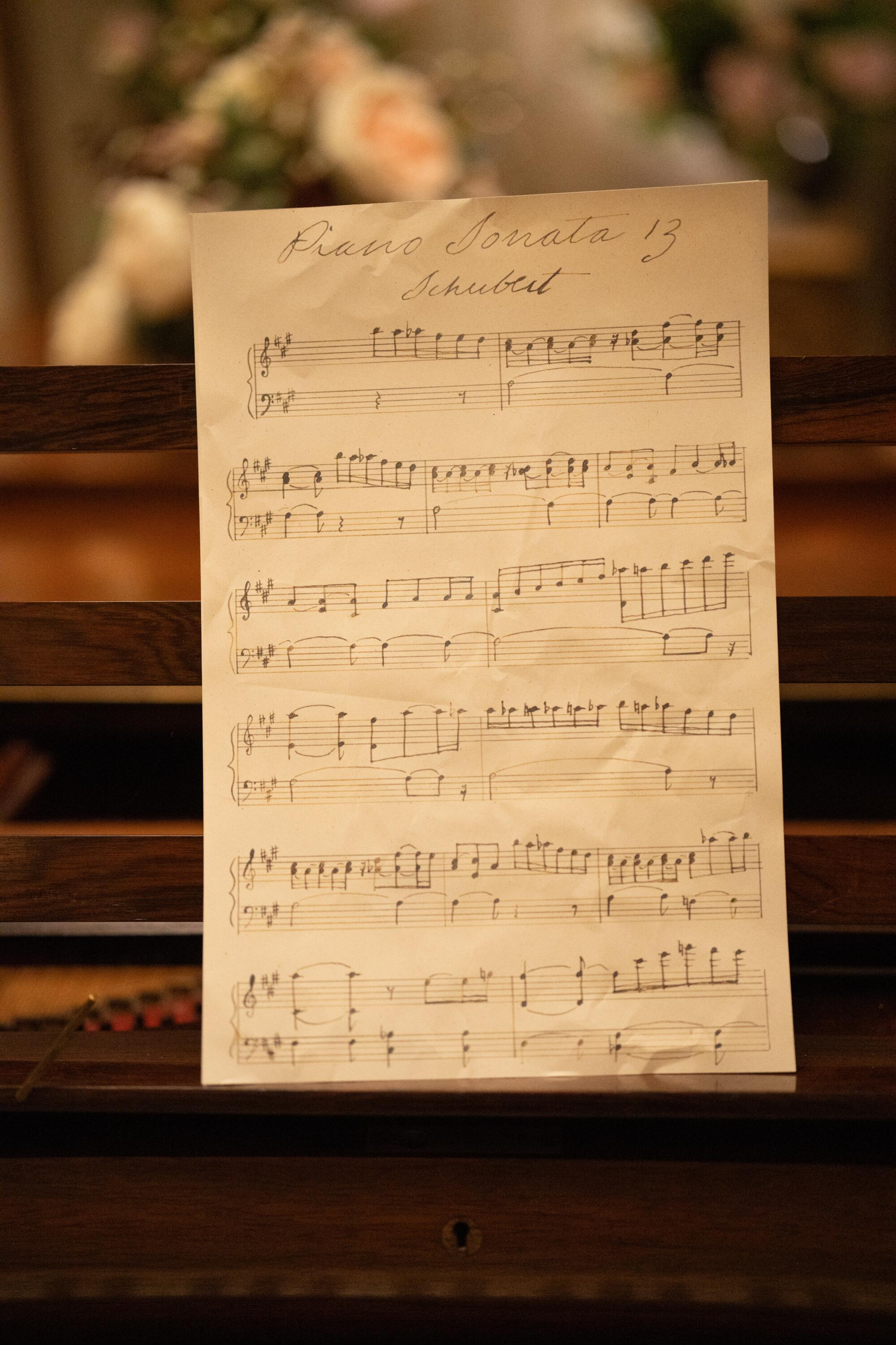 Sheet music rests on a piano.