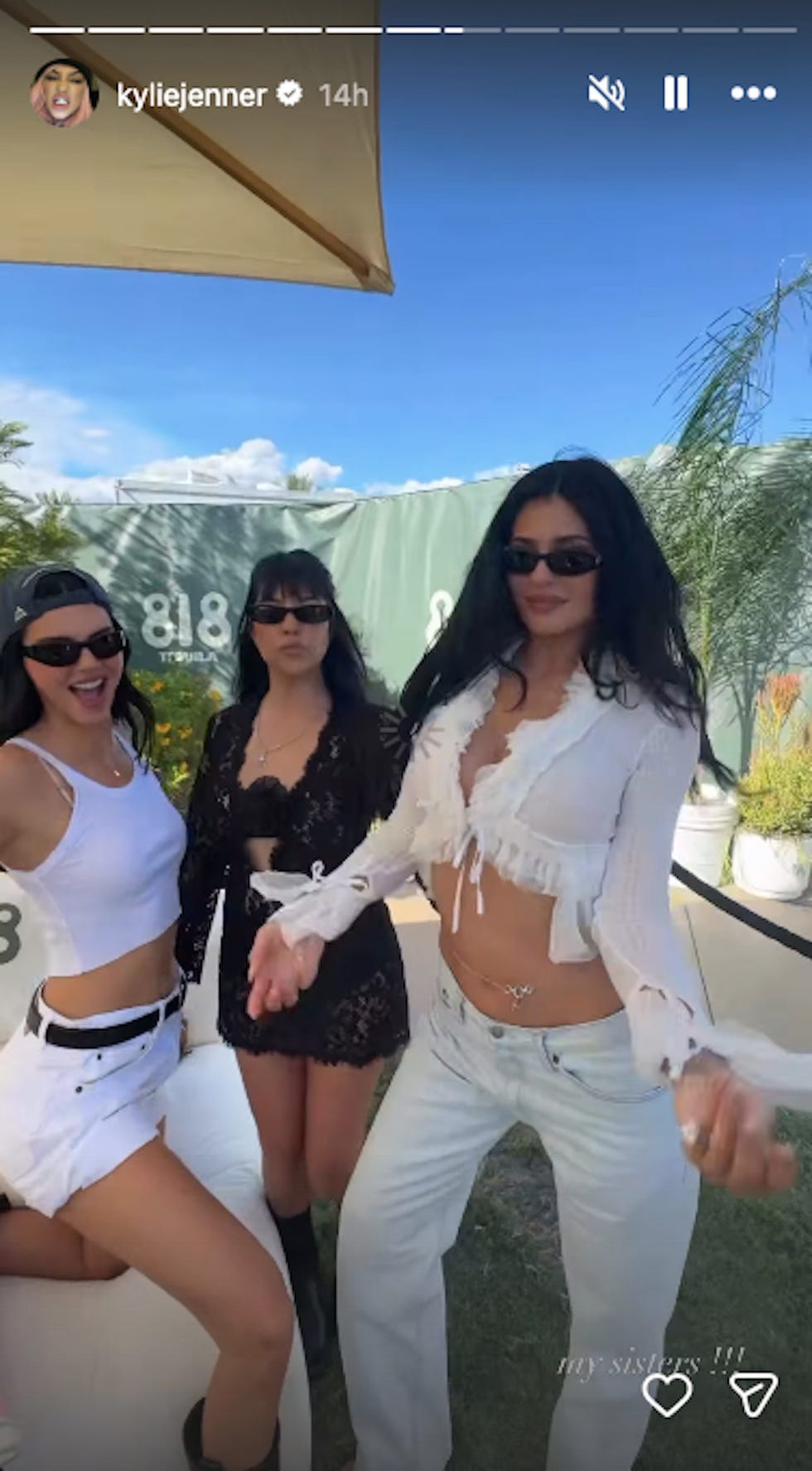 Group of three women posing together outdoors.