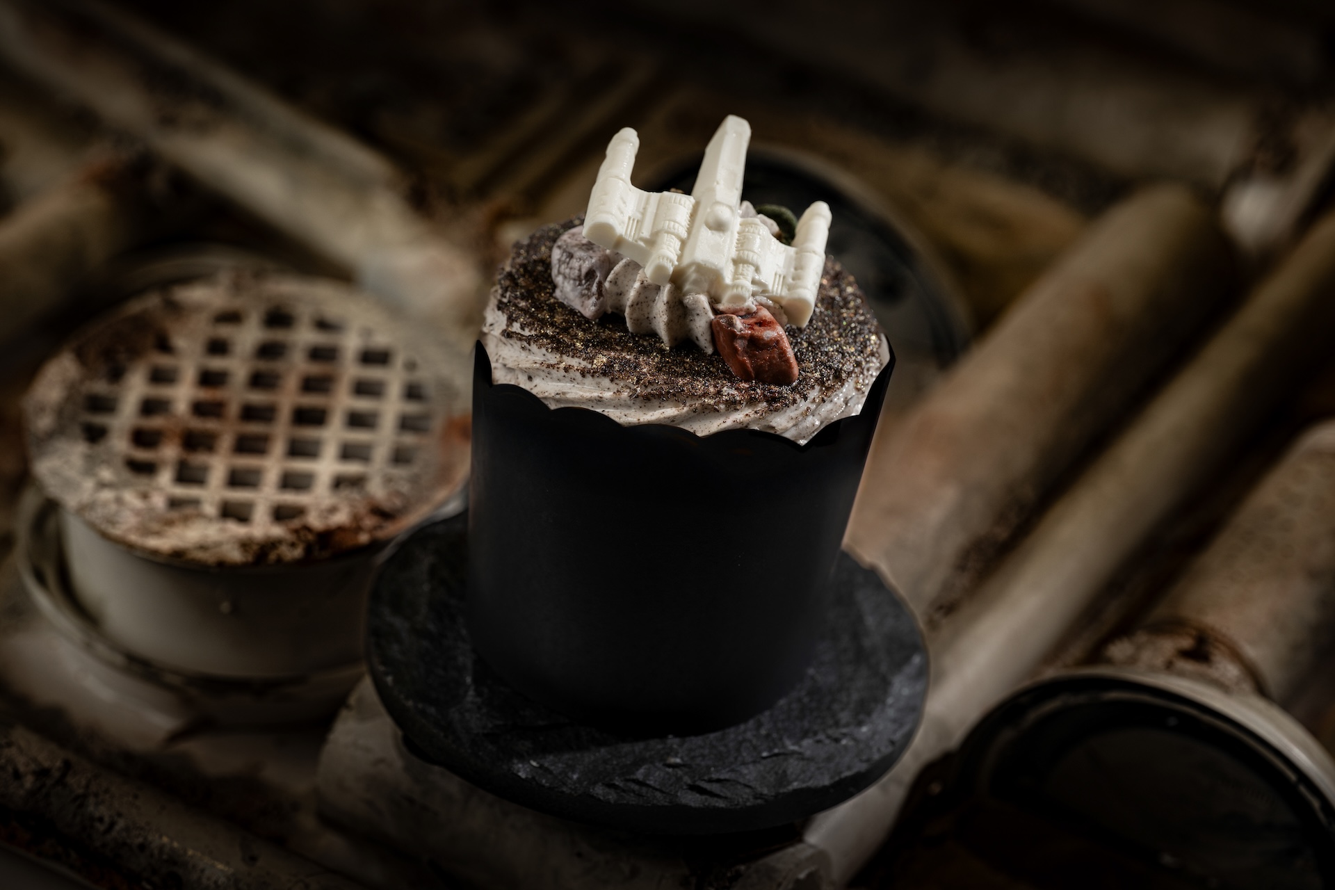 Your Chosen Path Cupcake: Cookies and cream cupcake, marshmallow buttercream, white chocolate X-Wing, and milk chocolate rocks. Inside the cupcake, a secret lightsaber color will reveal itself! (New)