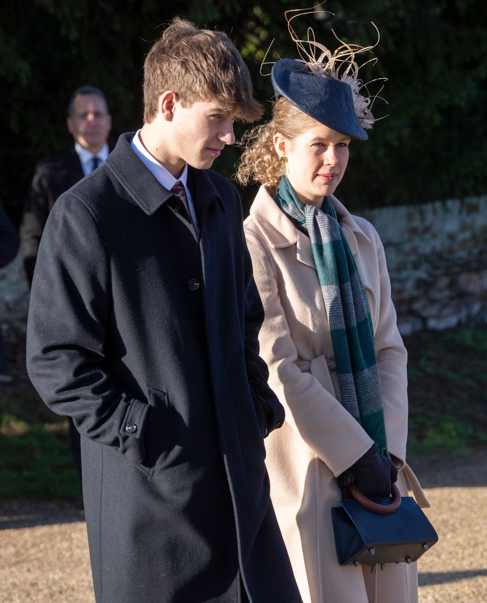 Image may contain Linda Hamilton David Campese Person Clothing Coat Adult Scarf Accessories Formal Wear and Tie